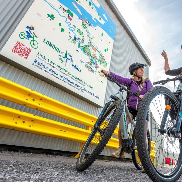Cyclists looking at the Avenue Verte tourist map in Newhaven port