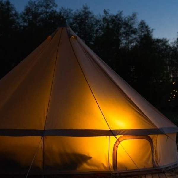 image shows a safari tent at night