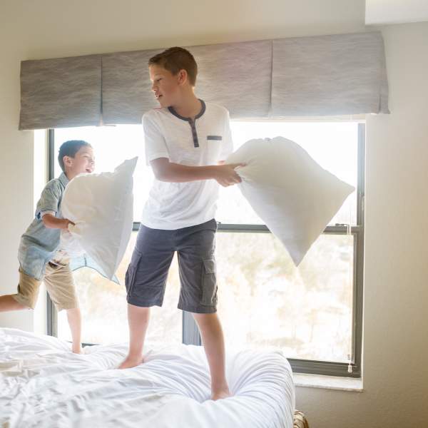 Holiday Inn Club Vacations® At Orange Lake Resort kids playing on bed in villa