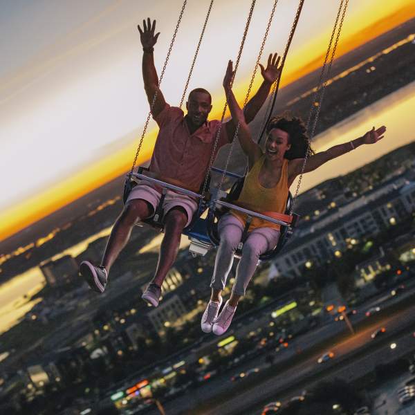 A couple riding the Orlando Starflyer at ICON Park