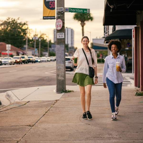 Two women walking down the street in the Mills 50 neighborhood
