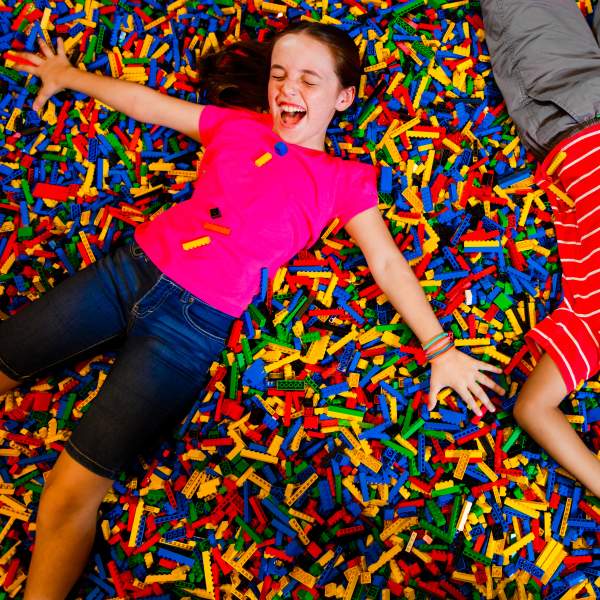 LEGOLAND® Florida Resort kids on bed of legos