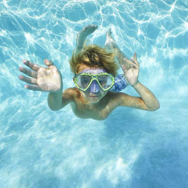 A boy swimming in hotel pool at Marriott Vacation Club