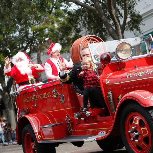 Santa rides a fire truck in the Winter Park Christmas Parade