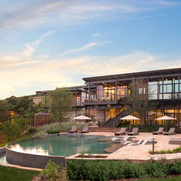 External building overlooking pool with umbrellas