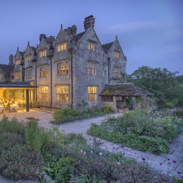 External view of Graveytye Manor and restaurant from the gardens, taken in the evening