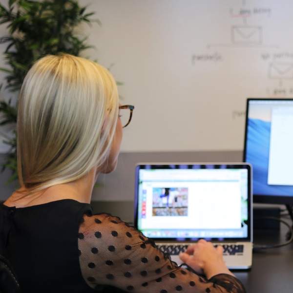 Photograph of two people working on computers