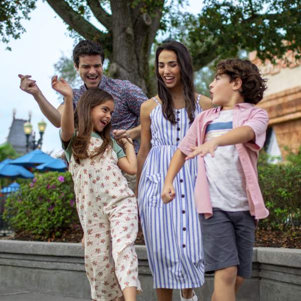 A family dancing in a theme park.