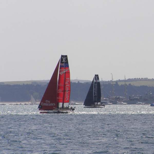 Photograph showing America's Cup catamarans racing in the Solent