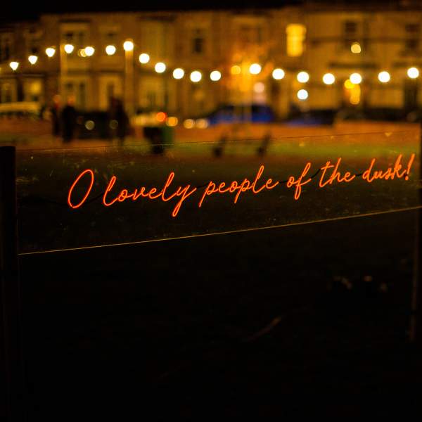 A light installation of glowing handwritten text