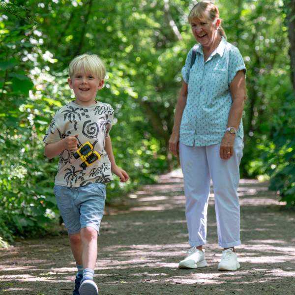 Grandparent and grandchild walking along Foxes Forest