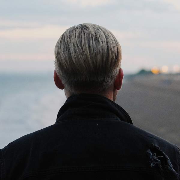 Photograph showing the back of a man on South Parade Pier looking out over Southsea Beach