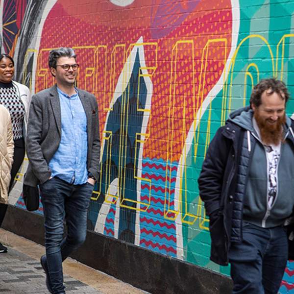 Group enjoying a street art walking tour with Seedhead Arts