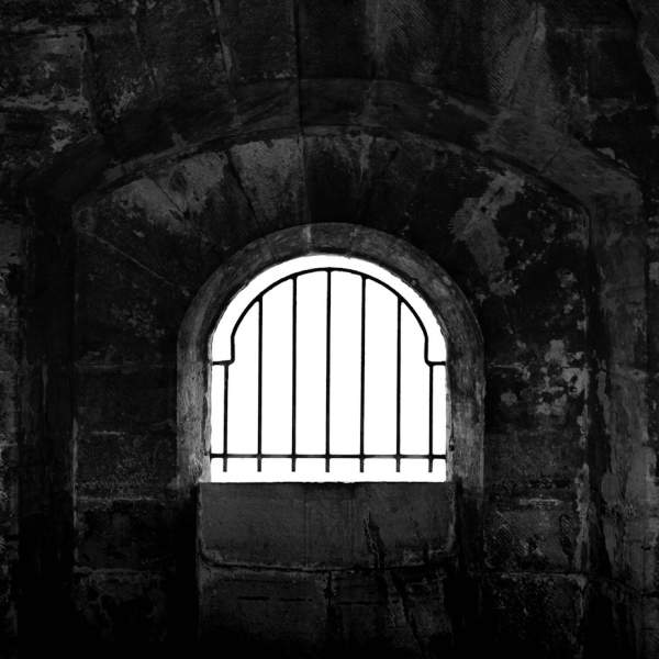 Black and white photograph of a grated window in the fortifications of Old Portsmouth