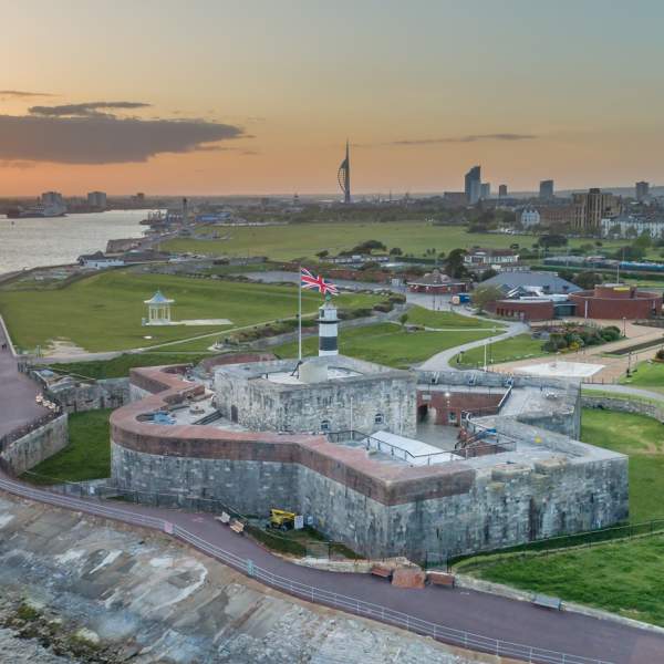 Photograph looking out over Southsea Castle, with Spinnaker Tower and the Portsmouth cityscape in the background