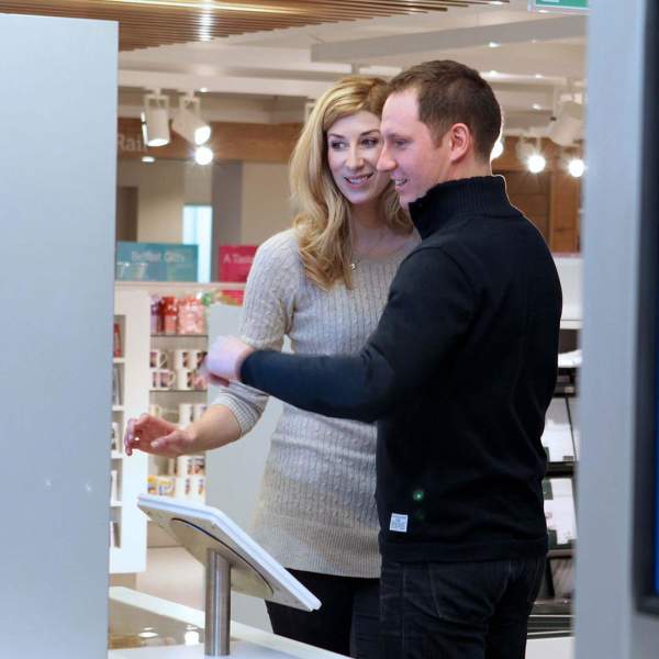 A couple viewing one of the display boards at the Belfast Visitor Centre