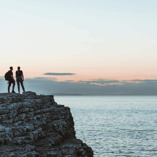 Couple walking the cliffs for sunrise at North Landing, Flamborough