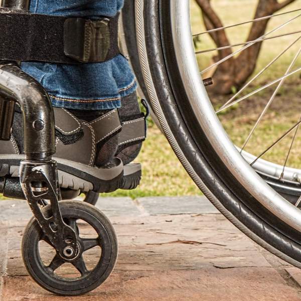 Photograph showing the bottom section of a wheelchair in use