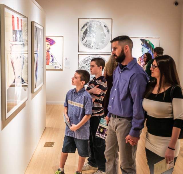 A family of four with two young sons viewing the display at a Cumberland County art gallery.