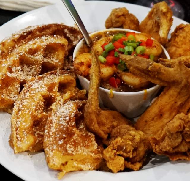 a plate of belgian waffle quarters with fried chicken