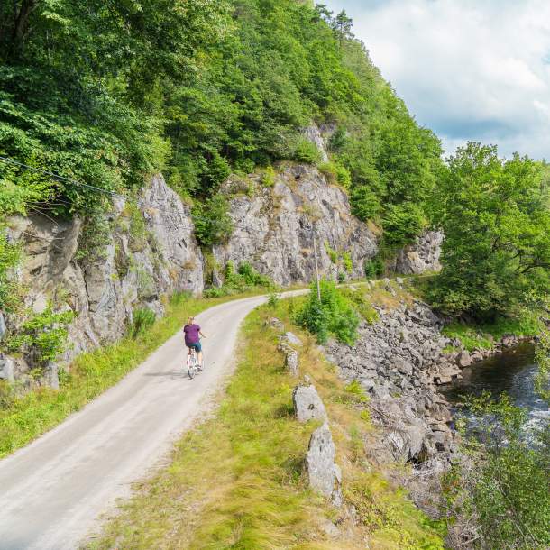 Woman biking along the river