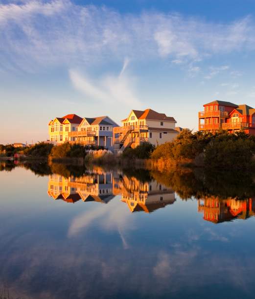 Homes sit on the water's edge, granting their occupants the best Outer Banks sunset views.