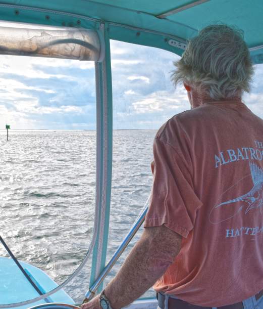 Captain Ernie Foster at the helm of an Albatross Fleet boat in the Outer Banks