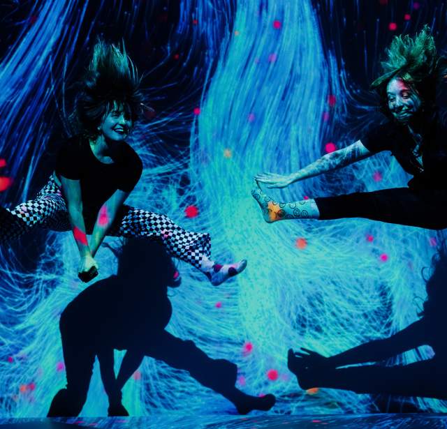 Two girls jumping in interactive museum
