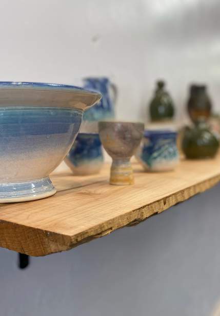 glazed pottery items on a shelf