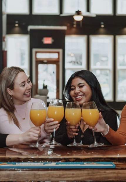 girls drinking mimosas at bar