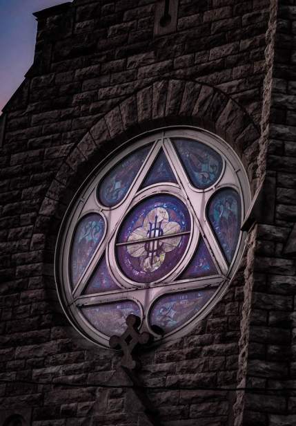 stained glass window in historic church at sunset