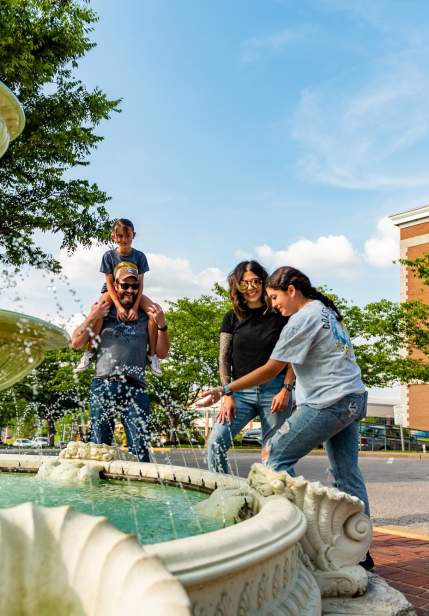 family by a downtown fountain