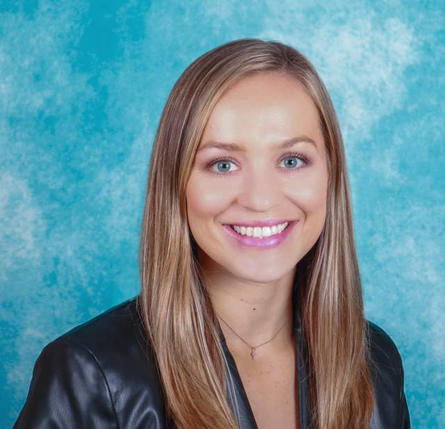 Woman's professional headshot on blue background