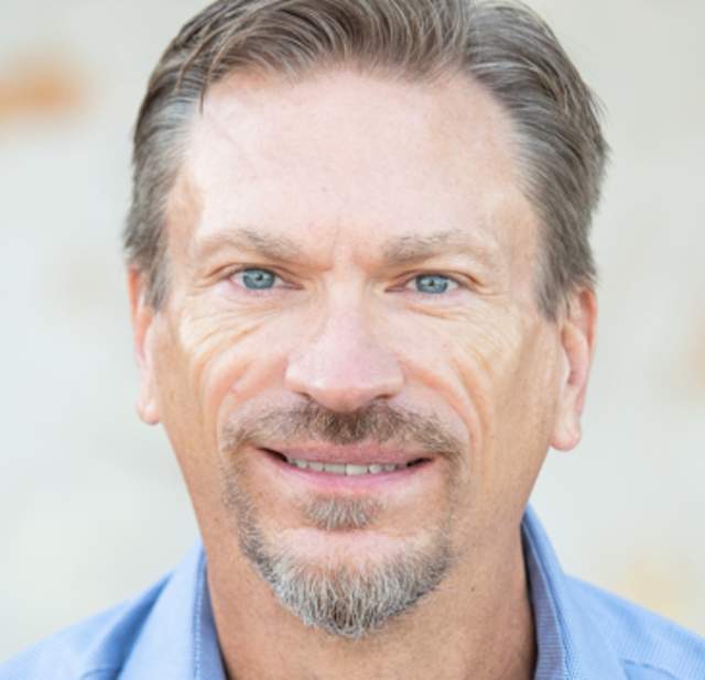 Rod Siebels smiling into the camera posing for a headshot.