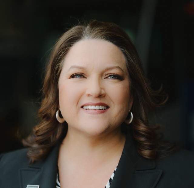 Dottie Watkins smiling and posing for a headshot.