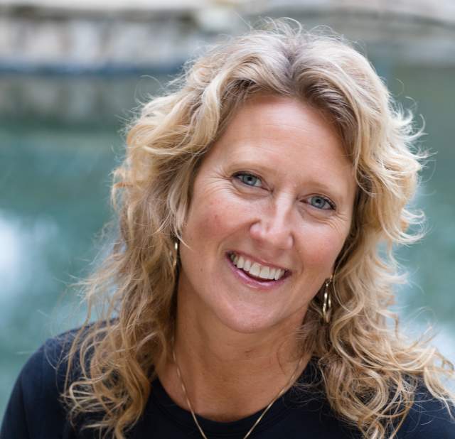 Dianne Bangle smiling at the camera posing for a headshot.