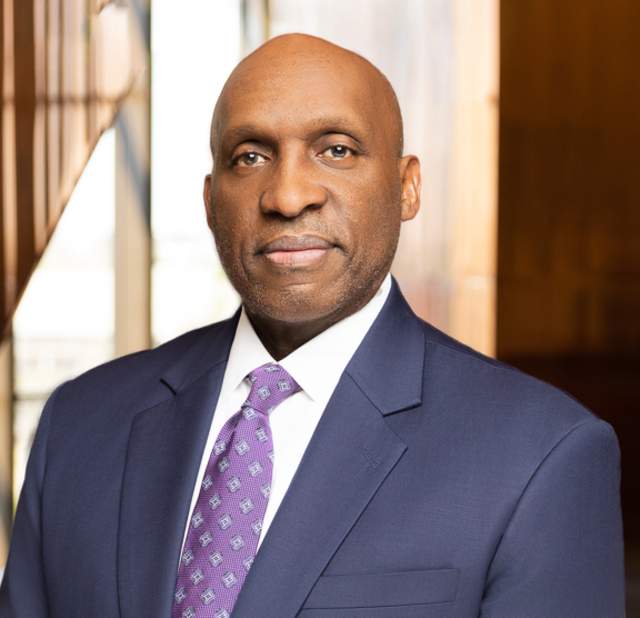 T.C. Broadnax in suit and tie posing for a headshot.