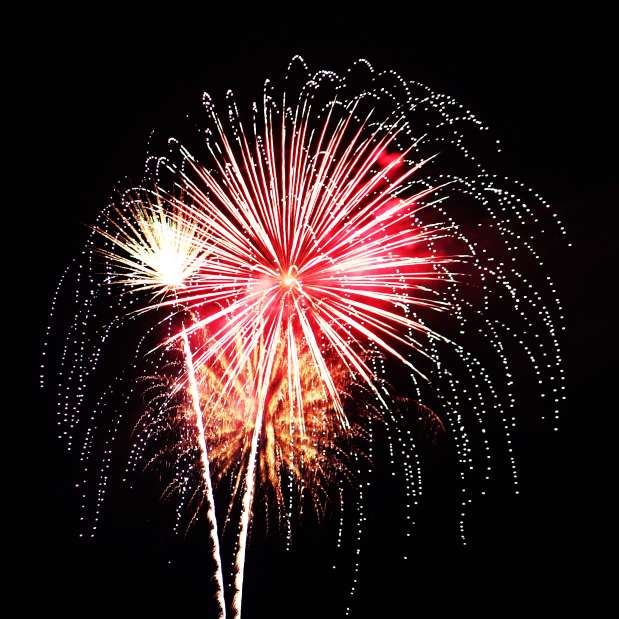 Pink and Orange Fireworks exploding in the sky