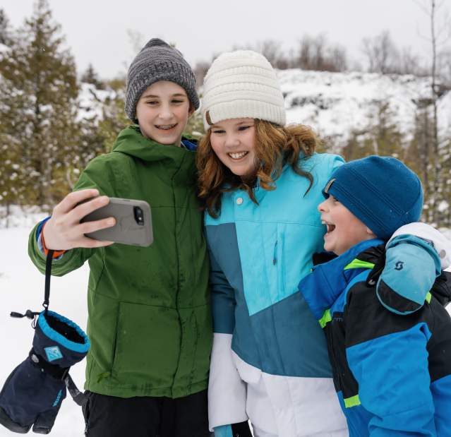 Siblings stop snowshoeing to take a selfie