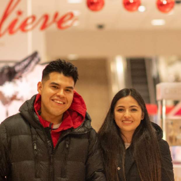 A couple poses for a photo inside of the mall