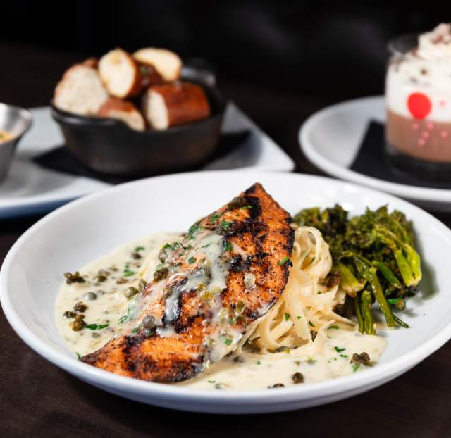 A table with plates of food from Red Door Woodfired Grill.