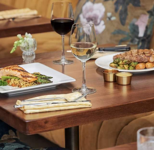 A table with plates of food from Gilded Feather.