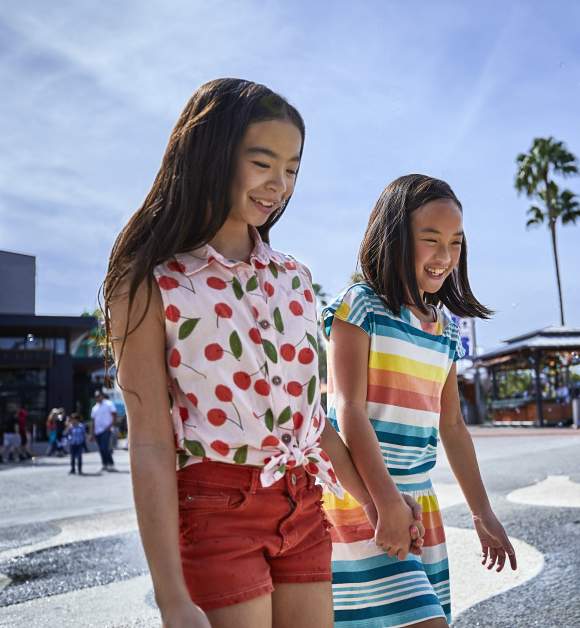 Two girls walking across a splash pad at Universal Citywalk Orlando