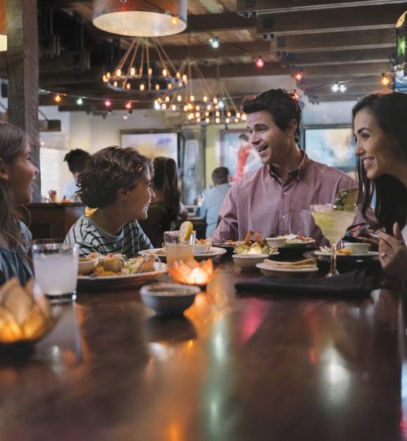 Family of four dining at Uncle Julio's at ICON Park