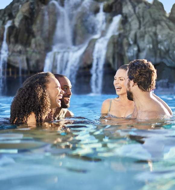 Two couples laughing in the water at Universal's Volcano Bay