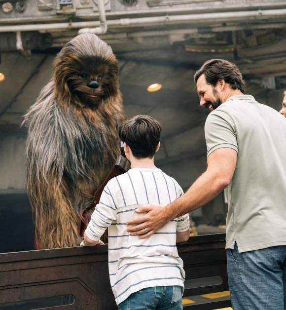 Kids meeting Chewbacca in Star Wars: Galaxy's Edge at Disney's Hollywood Studios in the Walt Disney World Resort.