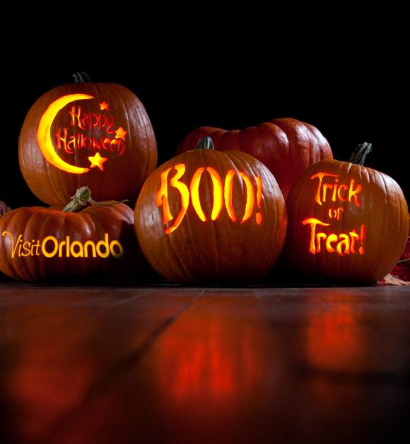 Pumpkins with Visit Orlando logo, Happy Halloween, Boo and Trick or Treat carved on them