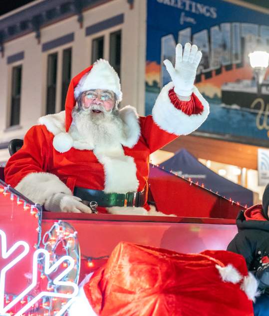 Santa waving with kid in Lakeshore Holiday Parade