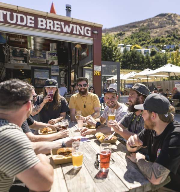 A group of people enjoying lunch and beers at Altitude Brewing