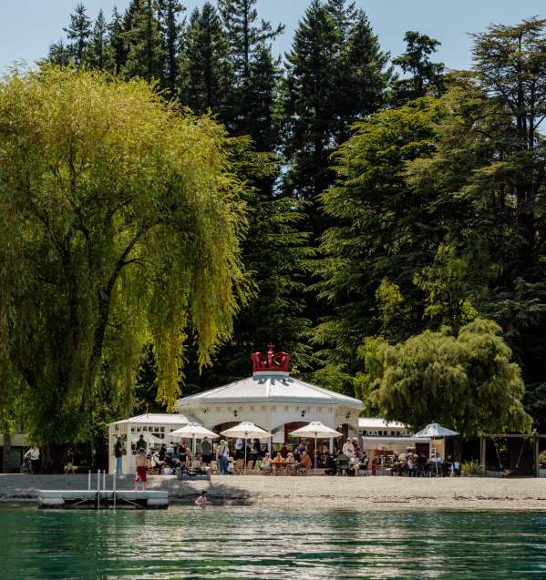 View from the lake looking back at a white cafe shaped like a crown - the Bathhouse Restaurant, a